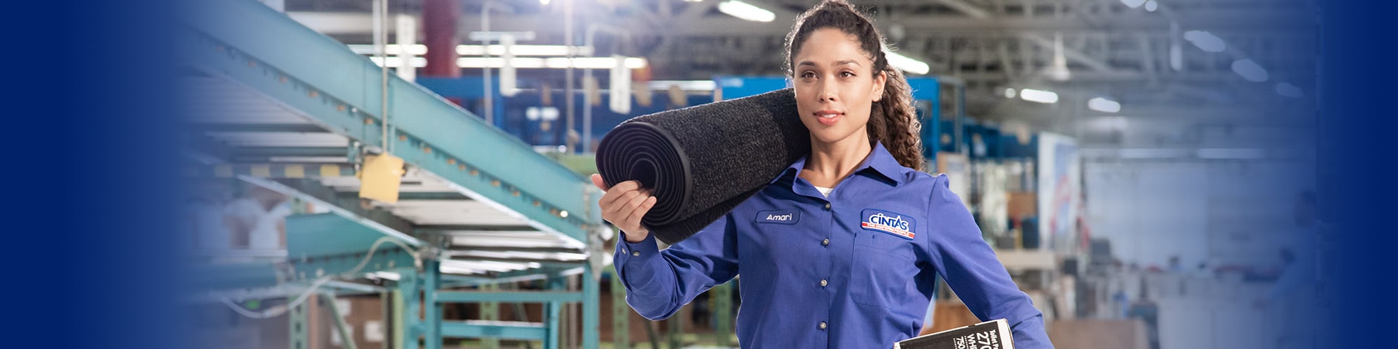 cintas service representative carrying floor mat
