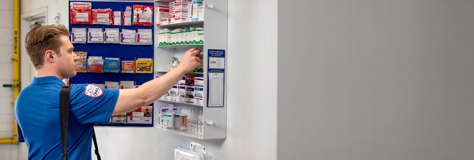 cintas first aid and safety rep servicing a first aid cabinet